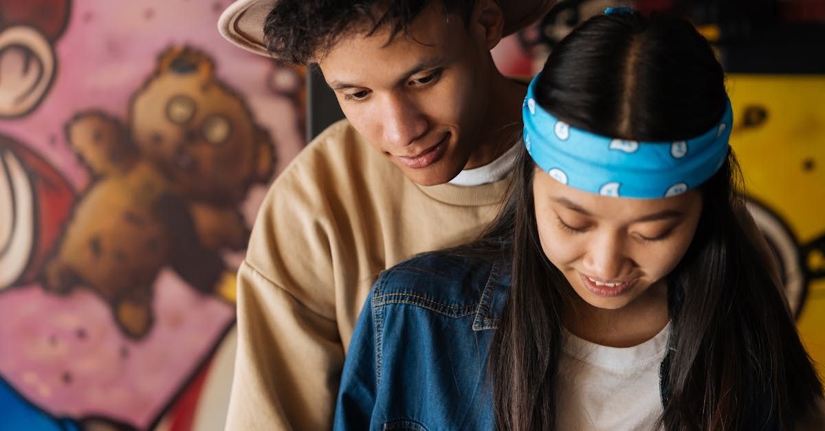 young woman wearing a blue bandana with a young man slightly behind her