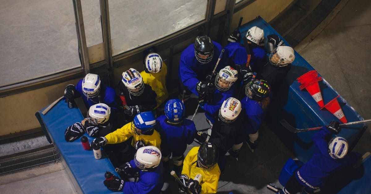 hockey team wearing blue huddled in a starting box