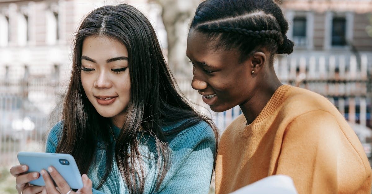 Image of two women searching on their smart phone.