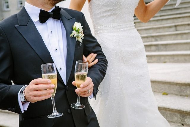 a man dressed in a tuxedo and a woman dressed in a white gown
