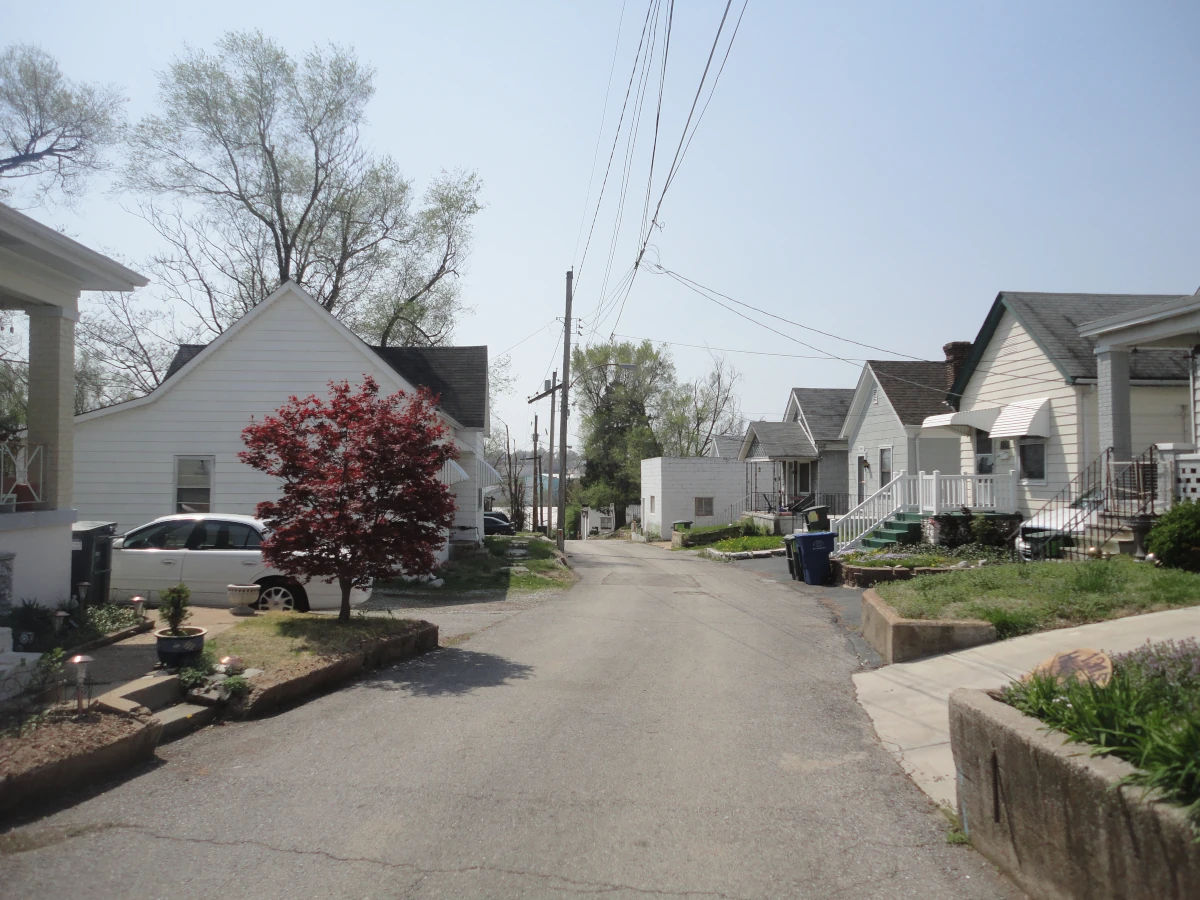 A small residential street lined with modest homes in the Cheltenham neighborhood of St. Louis