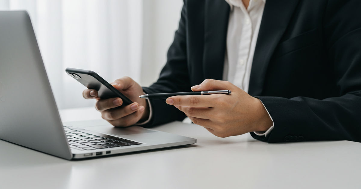 A small-business owner checking that their listing details match across a laptop and phone