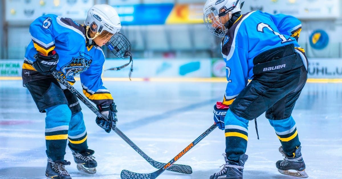 two hockey players ready to hit the puck