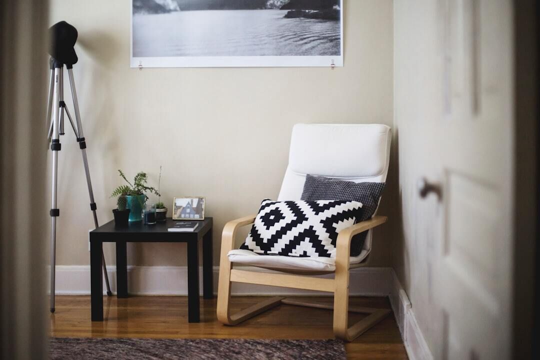 image of a comfortable chair side table and camera on a tripod