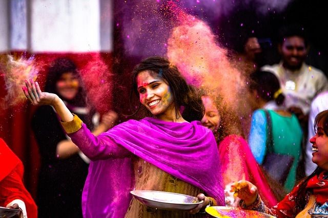 people wearing colorful clothing while celebrating their event