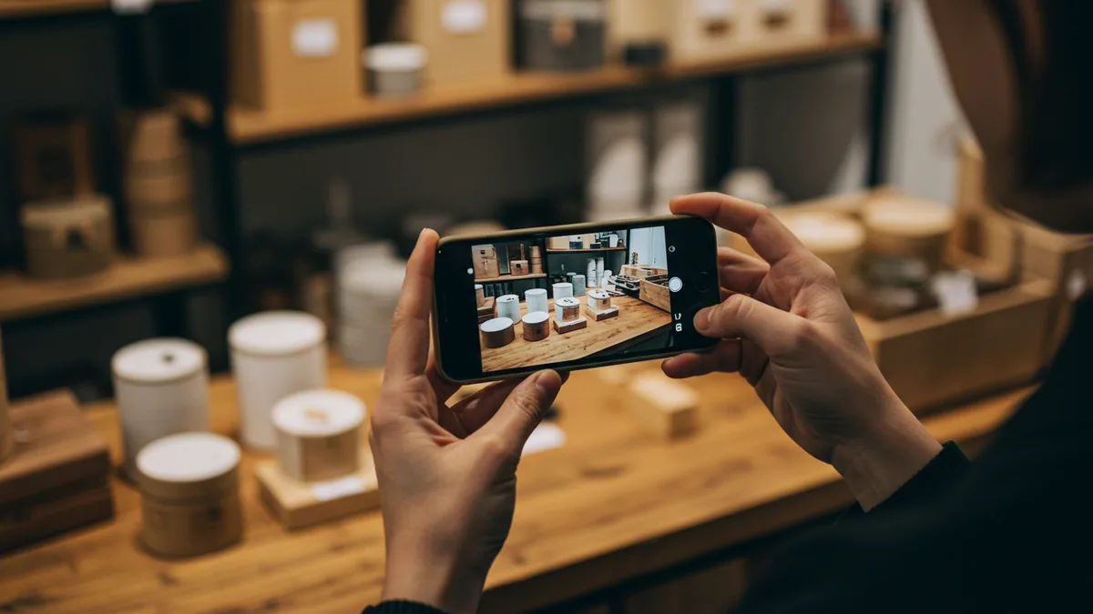 A shop owner photographing products with a smartphone for an online listing