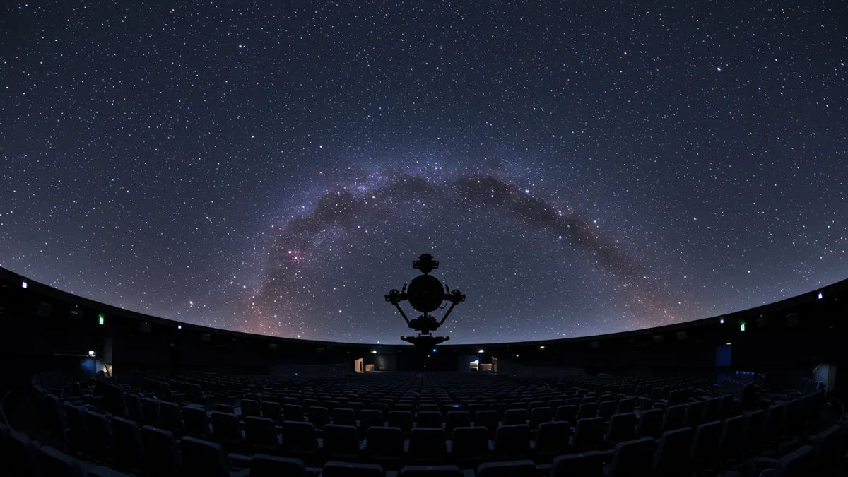 the interior dome of a planetarium show with a projected starry galaxy above rows of seats Editorial photograph, natural lighting, realistic, high quality. No text, no words, no le