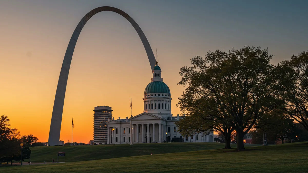 iconic St. Louis landmarks, the Gateway Arch beside the Old Courthouse dome at golden hour Editorial photograph, natural lighting, realistic, high quality. No text, no words, no le