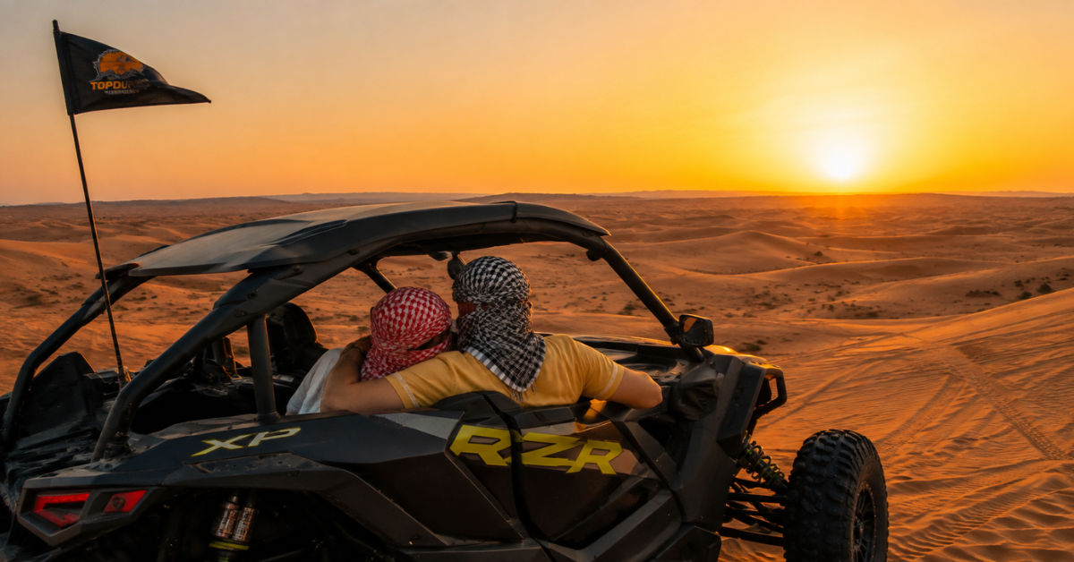 UAE resident couple enjoying sunset dune buggy weekend escape