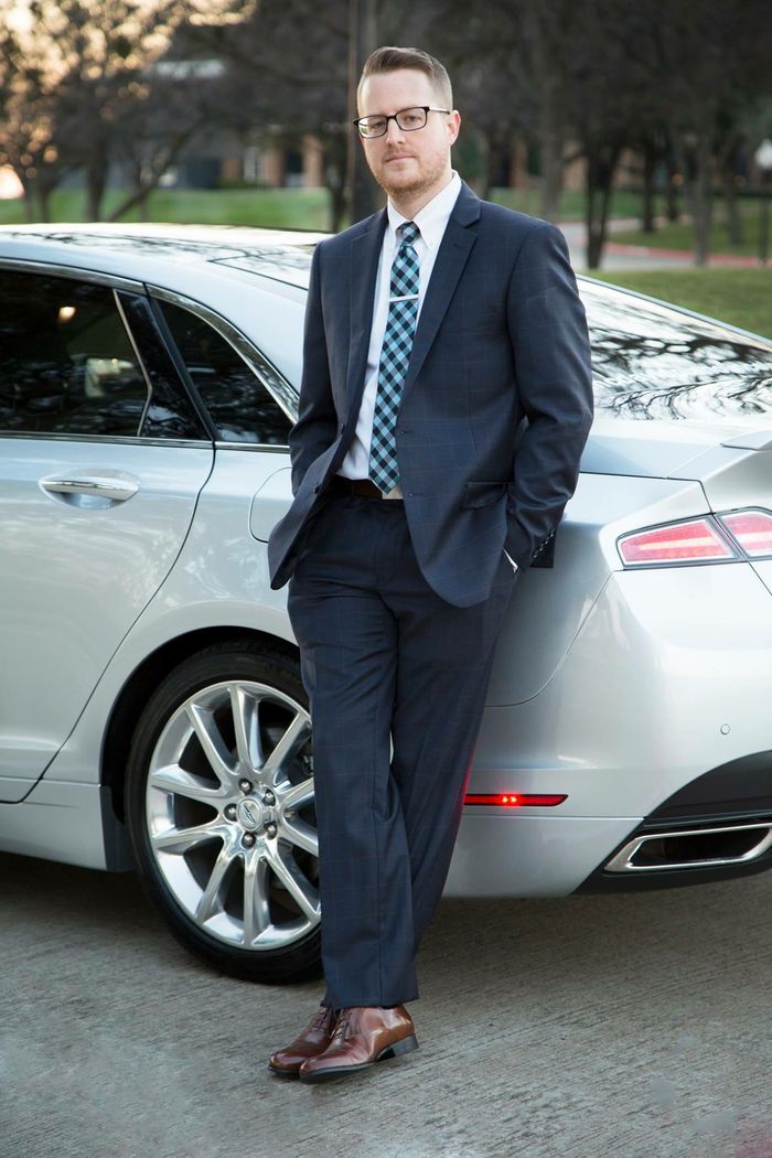 a portrait of me in a suit leaning against my car, a Lincoln MKZ