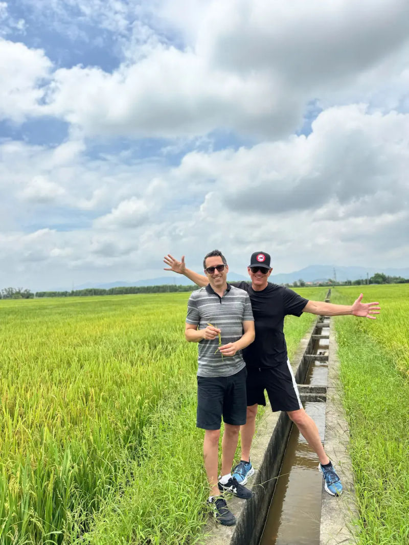 two American male tourist in Tra Que vegetable village - vietnameseprivatetours.com