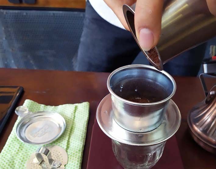 Add ground coffee into the filter