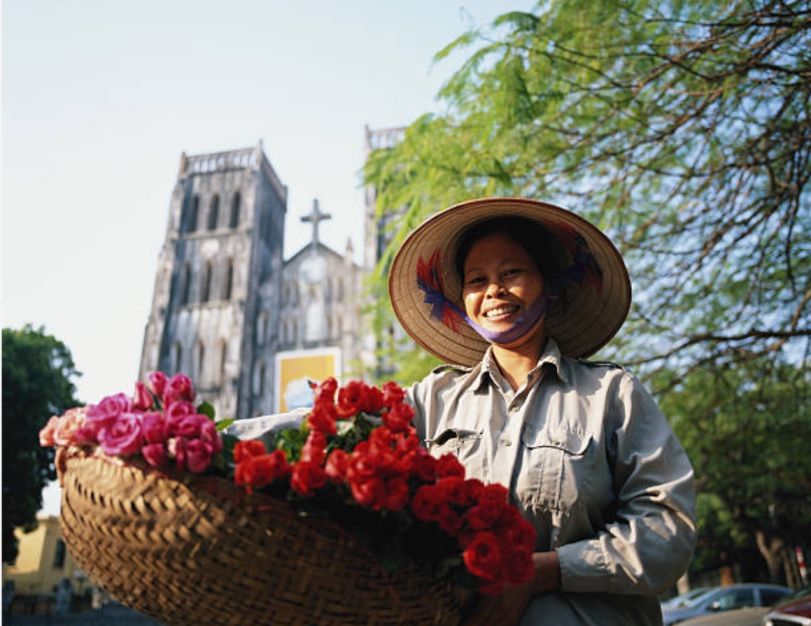 Vietnamese street vendor in Hanoi selling flower