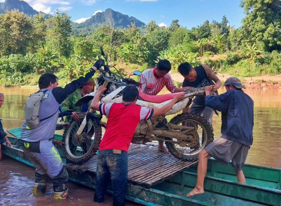 vietnam jungle - tourist pulling out the motorbike from the boat