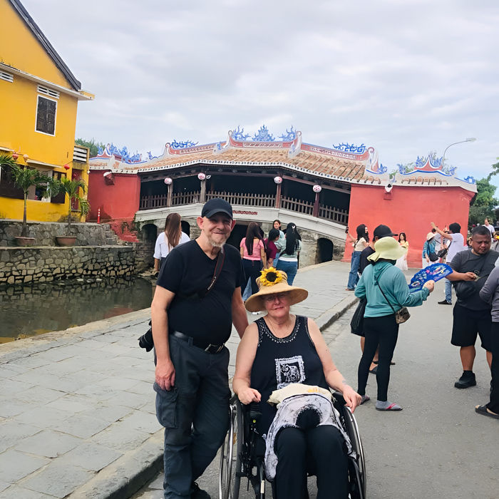 a couple from the UK on a wheelchair travel package enjoying the historic town of Hoi An