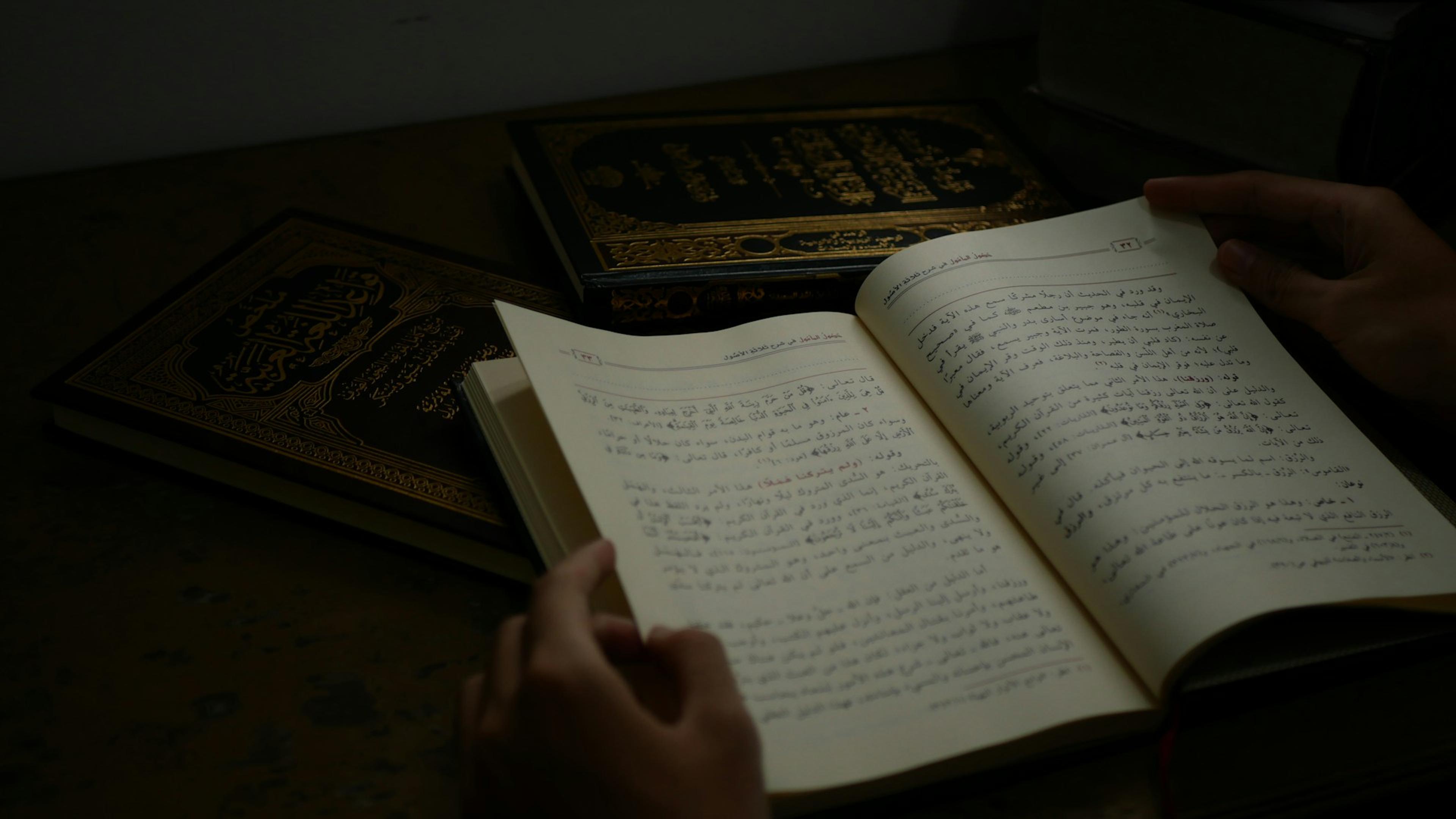 An open book photographed in soft light, representing Arabic input and study.
