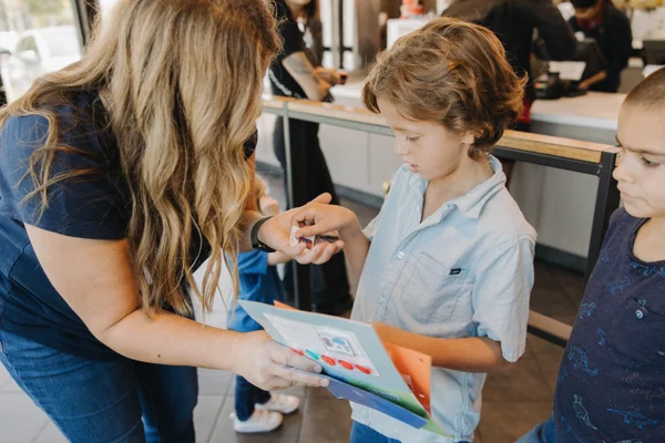 Team member helping child with autism