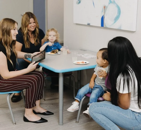 ACES team with children at table