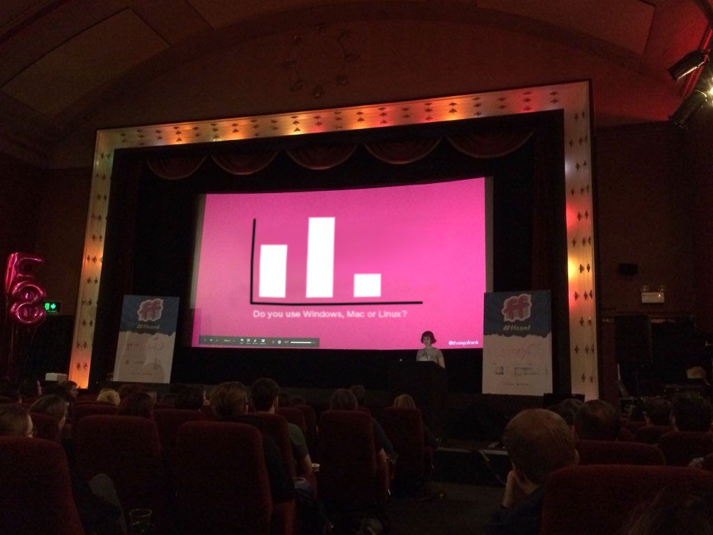 Jo on stage at a conference, polling the audience and showing live responses