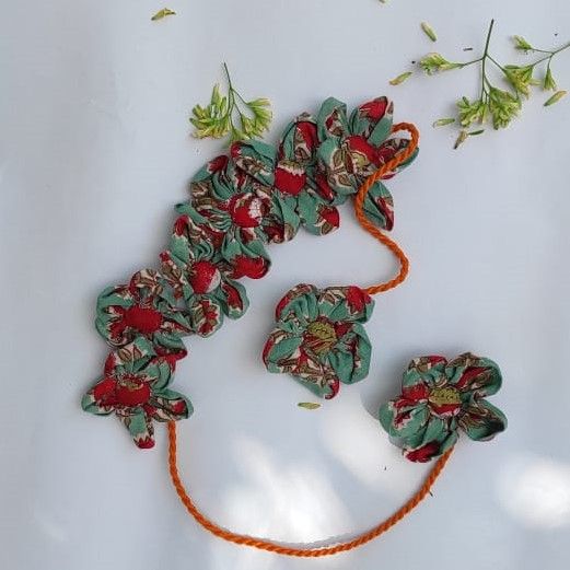 Handcrafted floral gajra adorned with colorful artificial flowers.