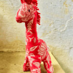 Sustainable handmade giraffe toy with embroidered details, crafted from cotton fabric.