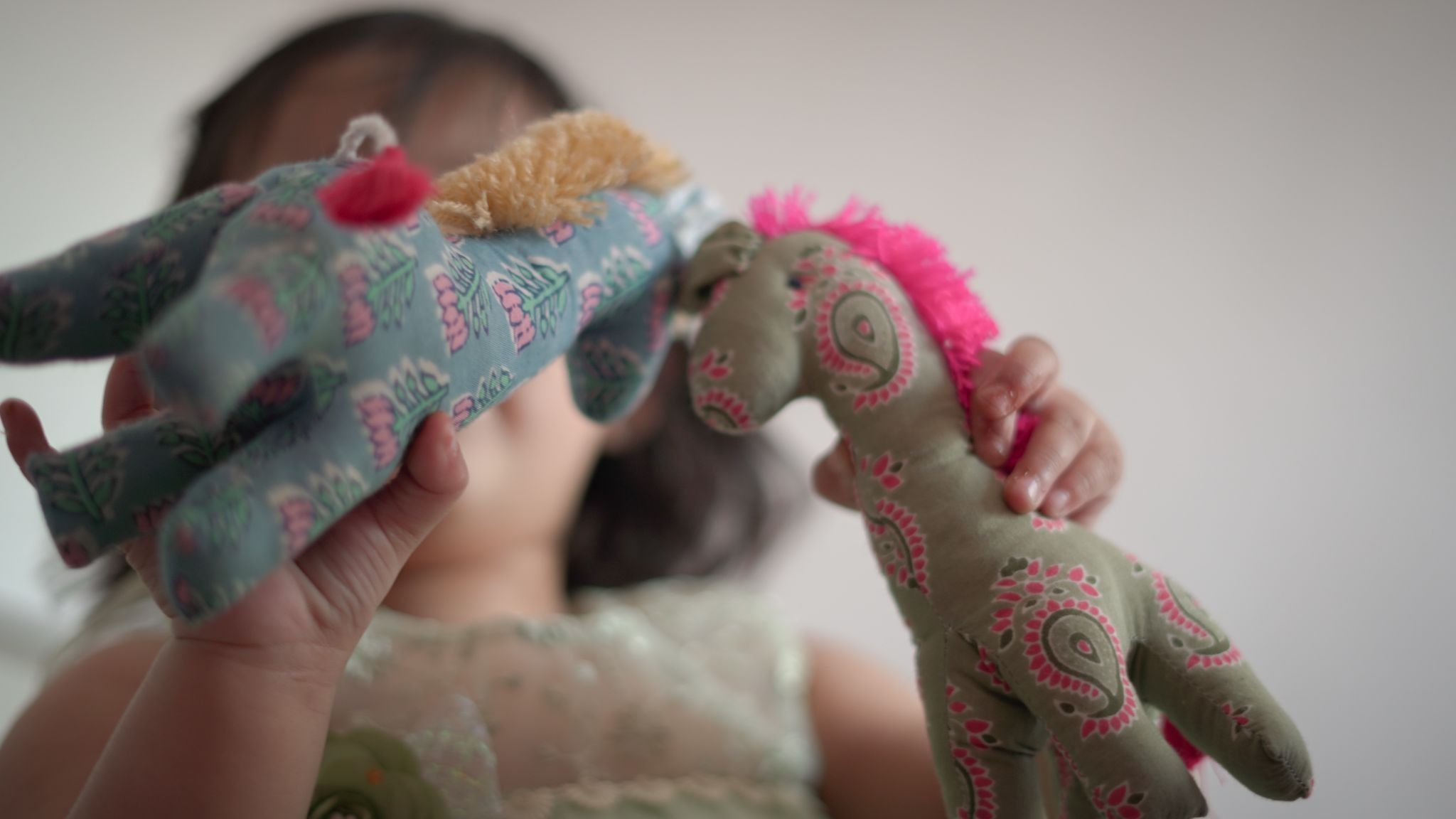 A kid playing with Mysa’s handmade cotton toys