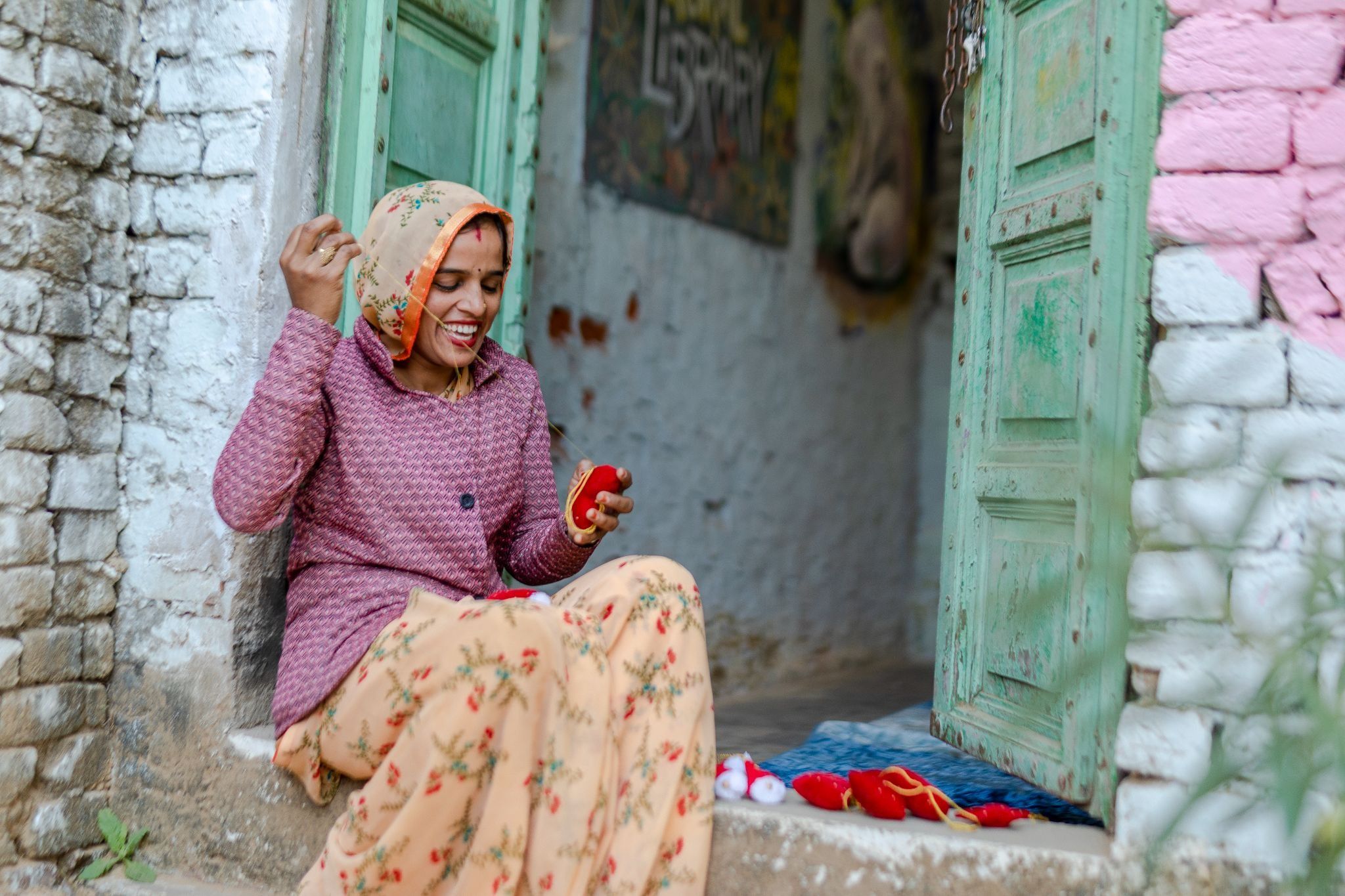 Woman artisan hand-stitching a fabric ornament at Mysa's Jaipur workshop