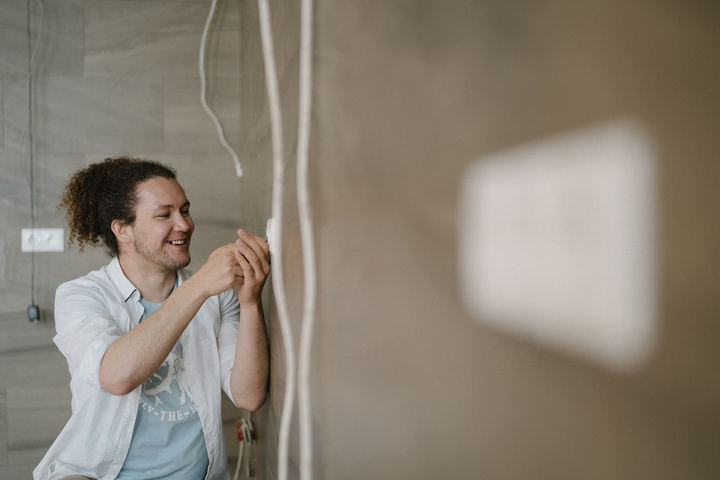 Licensed electrician working on an outlet, serving Waldport, Oregon