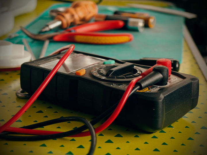 Electrician carrying out an electrical safety inspection of a panel and wiring in Waldport