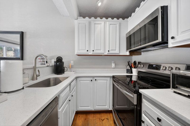 cook some meals in this full kitchen with microwave, stove, keurig, waffle maker, and toaster oven. Pots, pans, plates, bowls and cooking tools are all provided.
