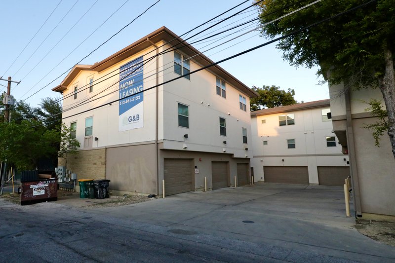 Modern multi-story exterior with attached garages and clean curb appeal