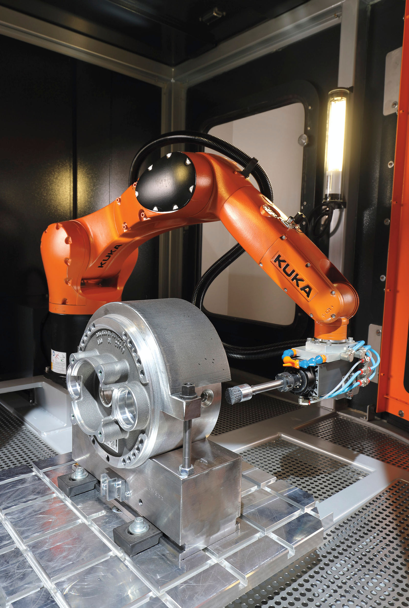 The KUKA KR Agilus is used to deburr a gear housing.