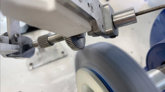 A cluster gear mid-cycle, seen from below. The OB7’s seventh axis allows compound approach angles that a 6-axis arm can’t reach.