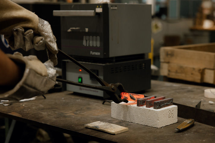 A heat-treated steel bar comes out of the furnace during a METAL bootcamp session—one of the core topics covered in both the online curriculum and hands-on training.