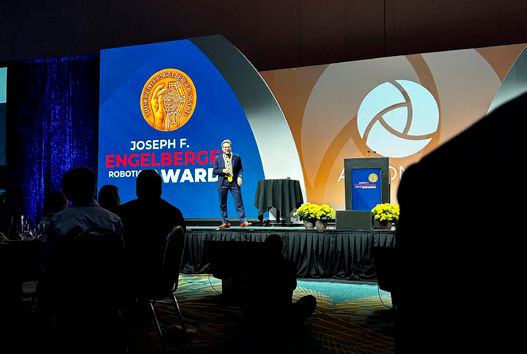 Jeff Burnstein receiving the Engelberger Award in 2023.