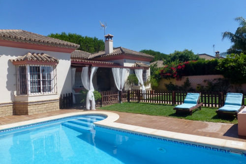 Villa Tasmania: Chiclana de la Frontera, Costa de la Luz, Spain. Garden, Garden and swimming pool and Sunbeds