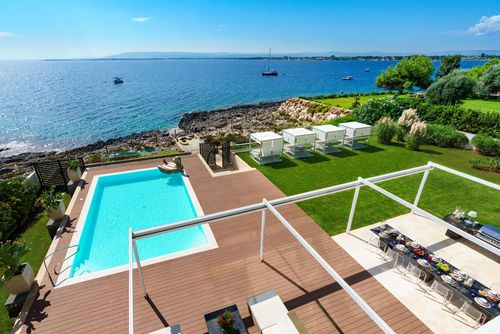 Villa Angelina Villa de luxe à Plemmirio, Sicile, Italie, avec piscine privée pour 8 personnes. La villa est située dans un quartier résidentiel en bord de mer, à 25 mètres d'un accès direct à la mer et aux rochers en contrebas de la plage....