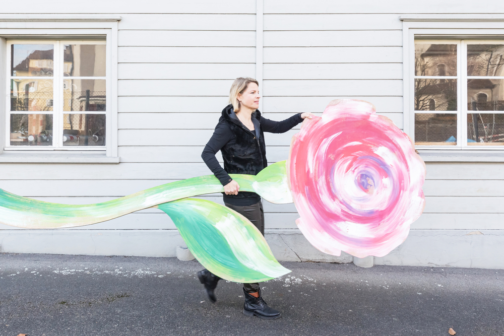Simone Kästli hat eine riesige Rose aus Karton in der Hand