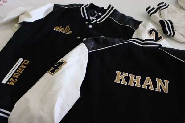 Letterman jackets with embroidered school logo and personalized names