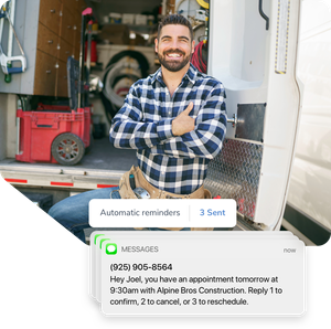 A contractor smiling in front of his van. An automated text message reminders his clients they have an appointment tomorrow.