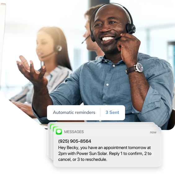 A sales professional assists a client on the phone. An SMS text reminder lets the client know about their upcoming appointment