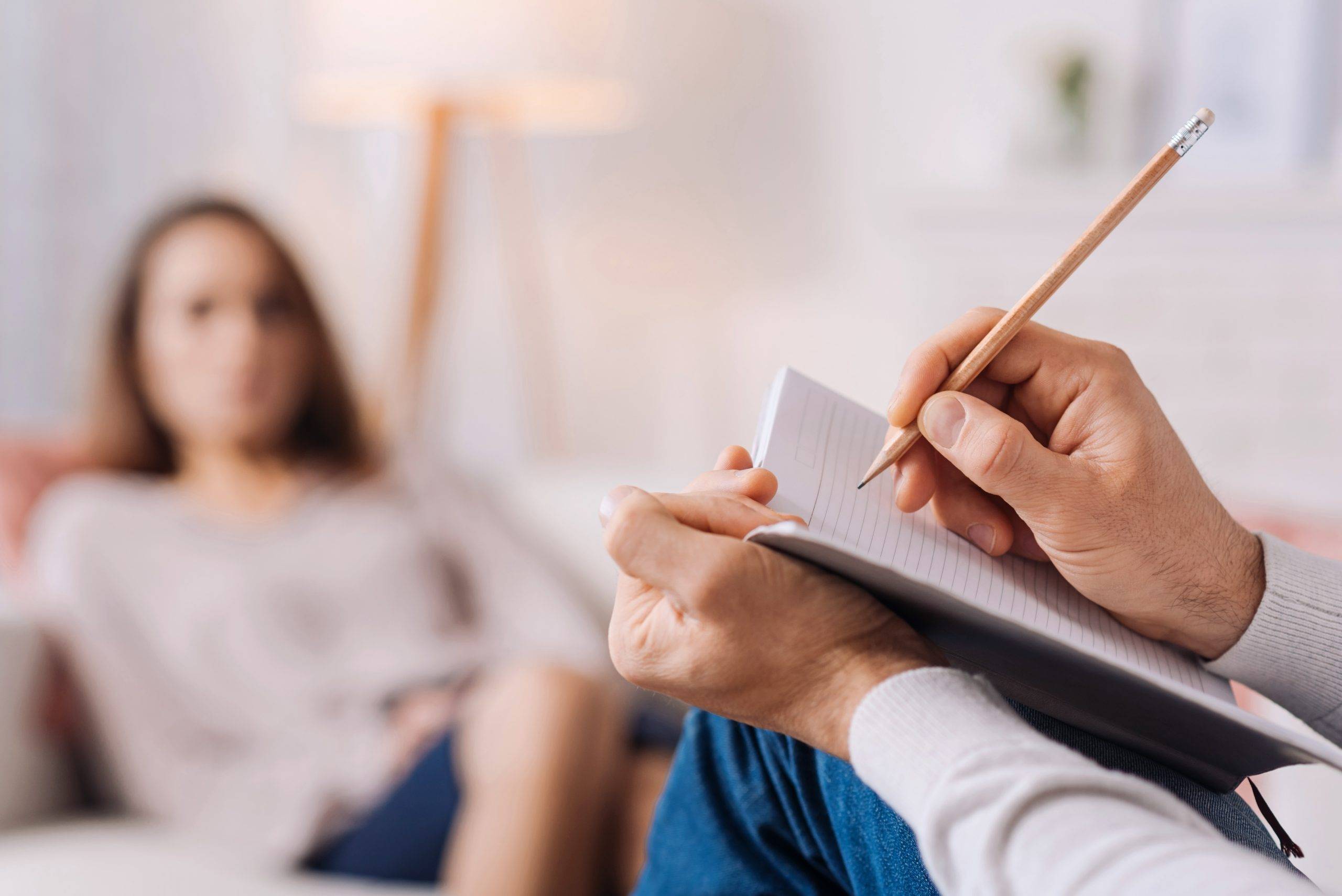 woman sitting on couch meeting with therapist.