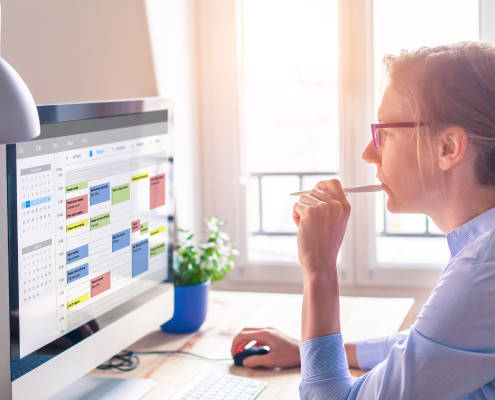 Woman evaluating her appointment calendar which utilizes an appointment booking app.