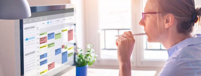 Woman evaluating her appointment calendar which utilizes an appointment booking app.