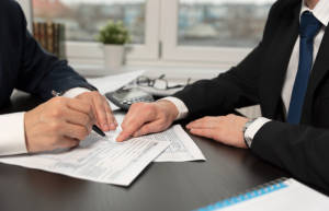 Person signs tax preparation documents after appointment