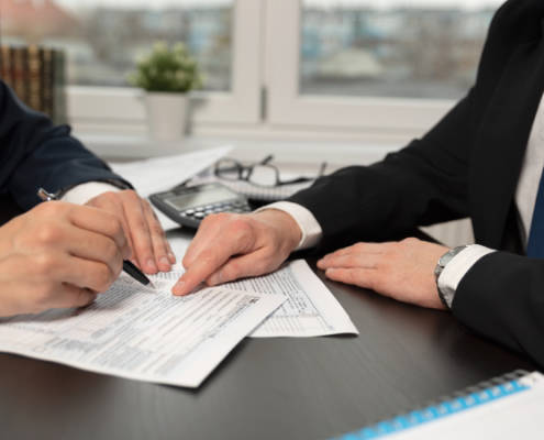 Person signs tax preparation documents after appointment