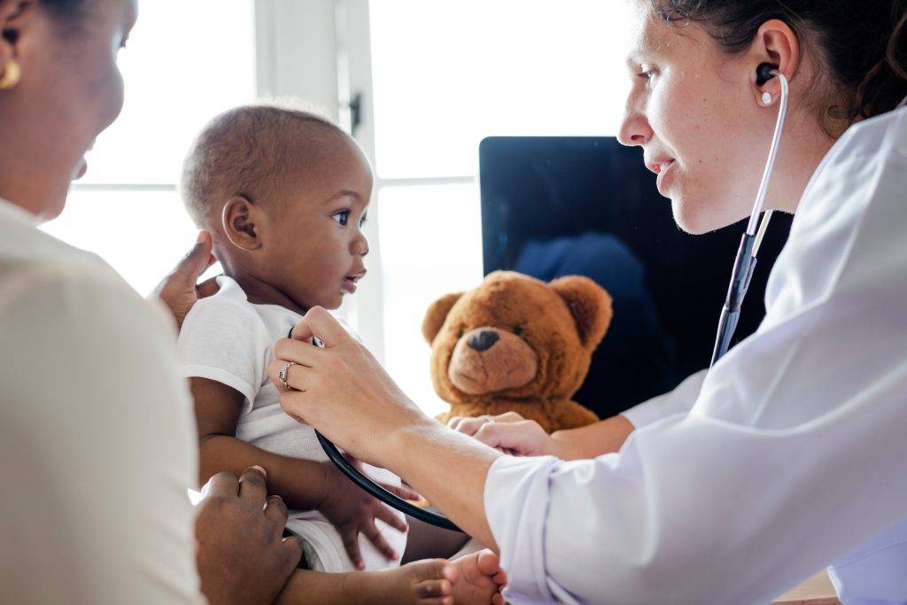 Baby being seen by doctor at healthcare appointment
