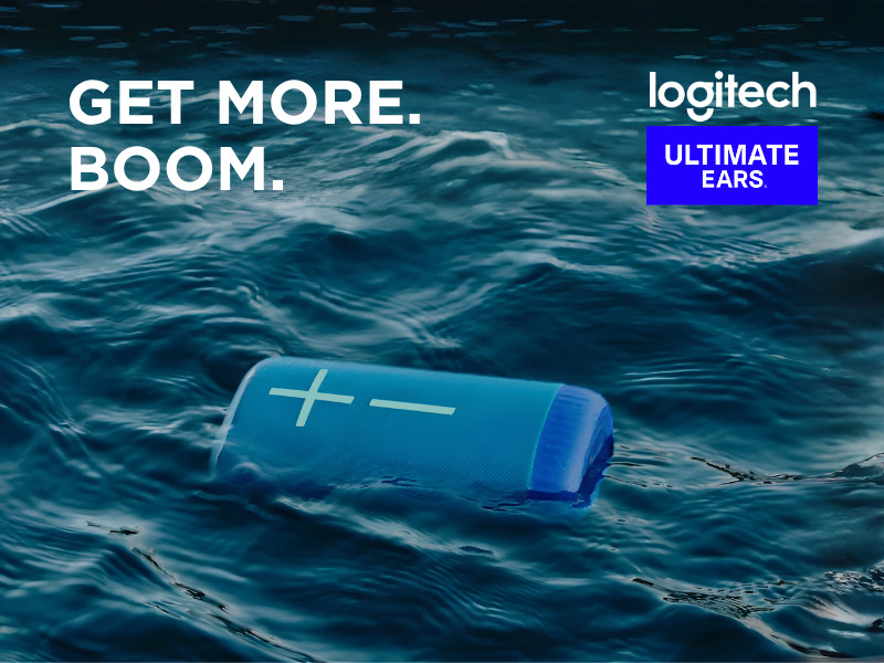 Logitech Ultimate Ears promotional graphic featuring a blue portable speaker floating in ocean water with “Get More. Boom.” text.
