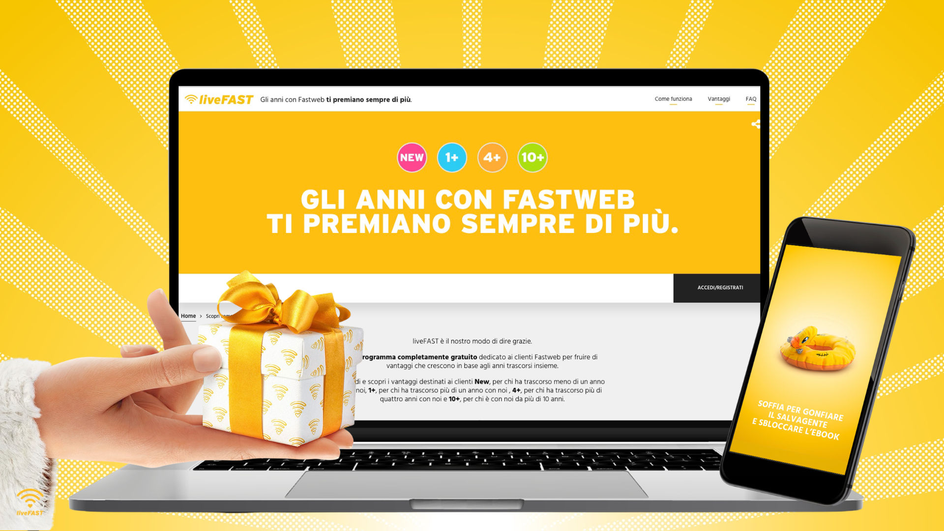 Um laptop e um smartphone exibindo um site promocional da Fastweb, com fundo amarelo e uma caixa de presente com snacks em destaque.