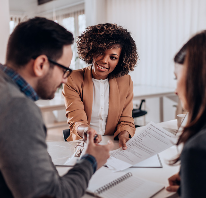 A woman and a man discussing a letter held by the woman